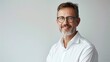 © Grigor - A smiling middle age businessman in white shirt and glasses isolated on light background.