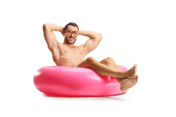 Wall Mural - Handsome man sitting on a swimming ring