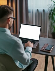 back view of business man freelancer sitting in home office at table