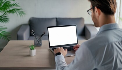 Back view of business man freelancer sitting in home office at table