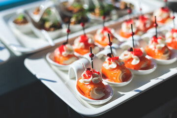 Wall Mural - Beautifully decorated luxury banquet catering table, with variety of with different food snacks appetizers on corporate birthday party event wedding celebration, canape, salad, delicatessen variety