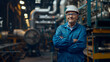 © Michael - Smiling mature male engineer with hard hat inside a manufacturing facility
