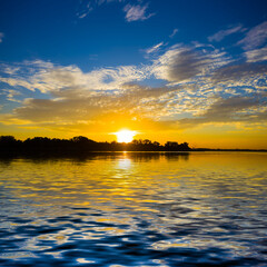 Wall Mural - dramatic sunset reflected in calm lake