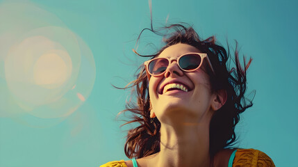 A joyful woman with sunglasses against a blue backdrop, exuding positivity and carefree summer vibes. Ideal for lifestyle and summer-themed designs, with ample copy space.