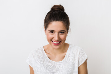 Wall Mural - close-up portrait young pretty woman smiling in white t-shirt on white background, happy, positive mood, isolated, sincere smile