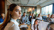 © Юлия Падина - Business meeting with a diverse team discussing a project in a modern office with a video conference in the background