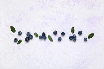 Wall Mural - Fresh blueberries and leaves on white background