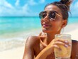 © Thibaut Design Prod. - Woman with sunglasses enjoying a drink on the beach