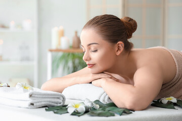 Wall Mural - Beautiful young woman relaxing in spa salon, closeup