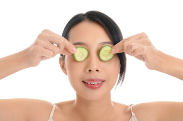 Poster - Beautiful Asian woman with cucumber slices on white background, closeup