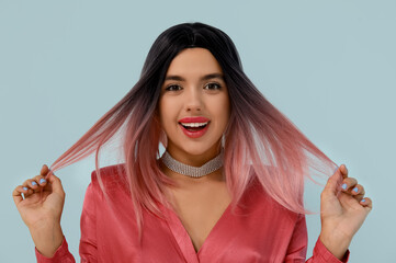 Poster - Portrait of beautiful young woman in wig on blue background