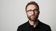 © MD Media - Man with beard and glasses wearing black polo shirt, neutral background