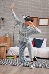 Canvas Print - Female student using VR glasses in bedroom