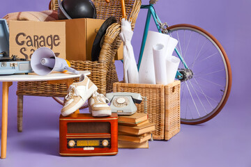 Unwanted stuff for garage sale on lilac background