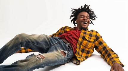 Happy young man with dreadlocks lying on the floor and laughing. Casual style wearing plaid shirt and ripped jeans. Perfect for lifestyle and fashion concepts, showcasing joy and youth. AI