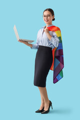 Canvas Print - Asian businesswoman with laptop and LGBT flag on blue background