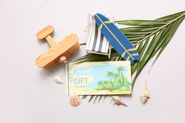 Sticker - Composition with travel gift voucher, mini beach accessories and palm leaf on light background