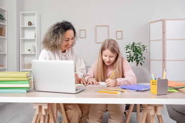 Wall Mural - Little girl studying Math with tutor at home