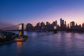 Wall Mural - Brooklyn Bridge and New York skyline across the East River under an intense sunset.