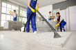© Pixel-Shot - Team of young janitors cleaning in room