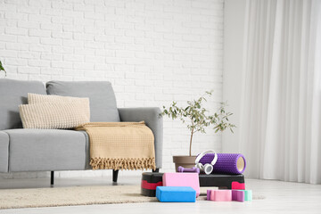 Poster - Sports equipment with headphones on carpet in living room interior