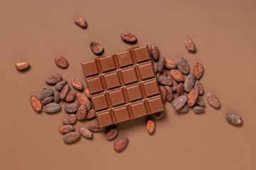 Wall Mural - Composition with tasty chocolate bar and cocoa beans on color background