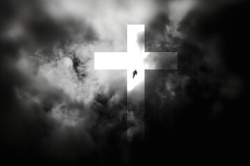 Wall Mural - Cross of Jesus Christ in the dark clouds. Silhouette of a man in the sky.