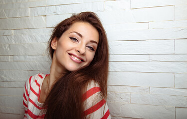 Wall Mural - Happy positive funny casual woman on studio white wall background with empty copy space. Closeup portrait with empty copy