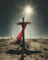 Easter, love and sacrifice. Cross with red cloth in the desert. 