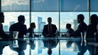 © Nicholas - Silhouetted figures sit around a boardroom table against a backdrop of a city skyline through panoramic windows