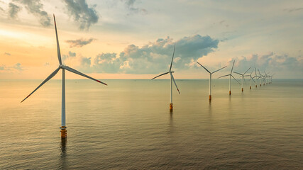 Wall Mural - windmill park with clouds and a blue sky, wind mill turbines in the ocean aerial view of a wind farm