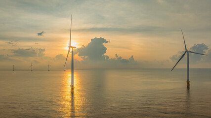 Wall Mural - windmill park with clouds and a blue sky, wind mill turbines in the ocean aerial view of a wind farm