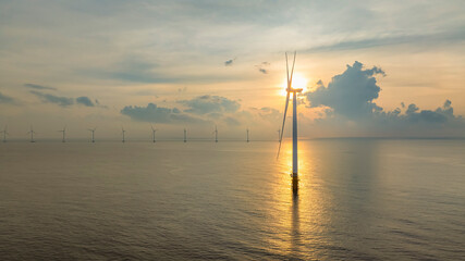 Wall Mural - windmill park with clouds and a blue sky, wind mill turbines in the ocean aerial view of a wind farm