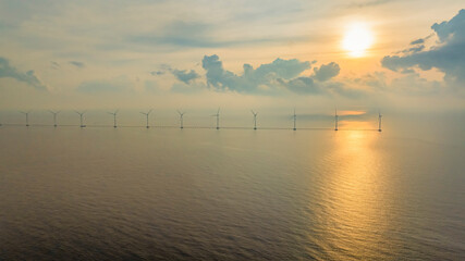Wall Mural - windmill park with clouds and a blue sky, wind mill turbines in the ocean aerial view of a wind farm