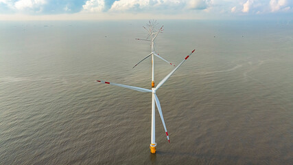 Wall Mural - windmill park with clouds and a blue sky, wind mill turbines in the ocean aerial view of a wind farm