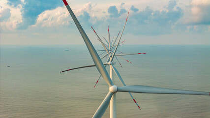 Wall Mural - Windmill park with clouds and a blue sky, wind mill turbines in the ocean aerial view of a wind farm in the Ba Dong beach, Tra Vinh, Vietnam production clean energy