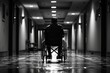 © aicandy - A solitary figure in a wheelchair moves along a dimly lit corridor, illuminating the silent echoes of resilience and solitude in a poetic interplay of light and shadows
