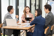 © ArLawKa - A team of Asian businessmen meets on a company budget to analyze and discuss the financial report situation in the conference room. investment consultant financial advisor