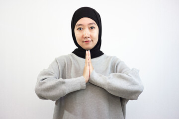 A Muslim girl is praying. Isolated on White Background