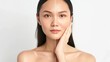 © Ndoomyim - A young woman with clear skin on one side of her face, and less clear skin on the other.