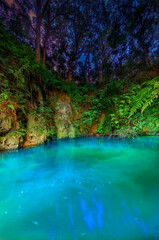 Wall Mural - A Sink Hole Illuminated at Night in Florida