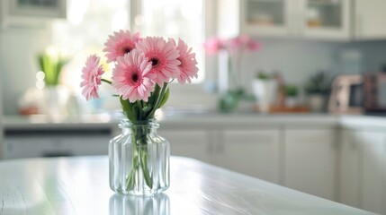 Wall Mural - A vase of pink gerbera daisies on a white table, in a chic modern kitchen, emphasizing playful and stylish decor. --ar 16:9 --style raw Job ID: 12b20869-a5e1-44f1-bb50-8cb26ec940ed
