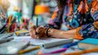 © BOONJUNG - Close-up of creative female designer drawing fashion sketch with design tools on desk