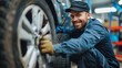 © Photolife   - portrait of a kind, smiling Caucasian auto mechanic changing tires on rims in a car repair shop. changing tires in a car repair shop
