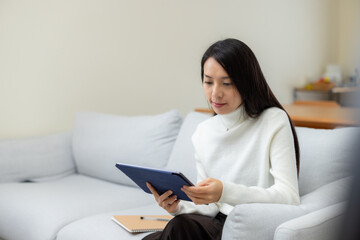 Sticker - Woman watch on tablet computer at home