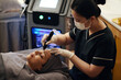 © DragonImages - Woman getting microneedling cosmetic procedure in beauty clinic
