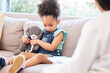 © Talia Mdlungu/peopleimages.com - Child, sad and therapy in clinic for mental health, depression and conversation in doctors office. Young, girl and teddy bear for support, psychology and wellness for trauma on couch with therapist