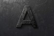 © Ева Поликарпова - Close-up of a metal letter A on a black background