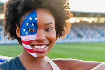 A young black woman who is a fan of the U.S. team in the stadium during the Olympics with the American flag painted on her face