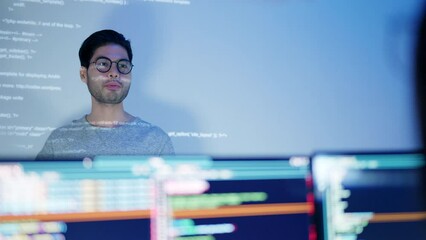Wall Mural - an asian male tech specialist passionately explains coding concepts during a nighttime team meeting.